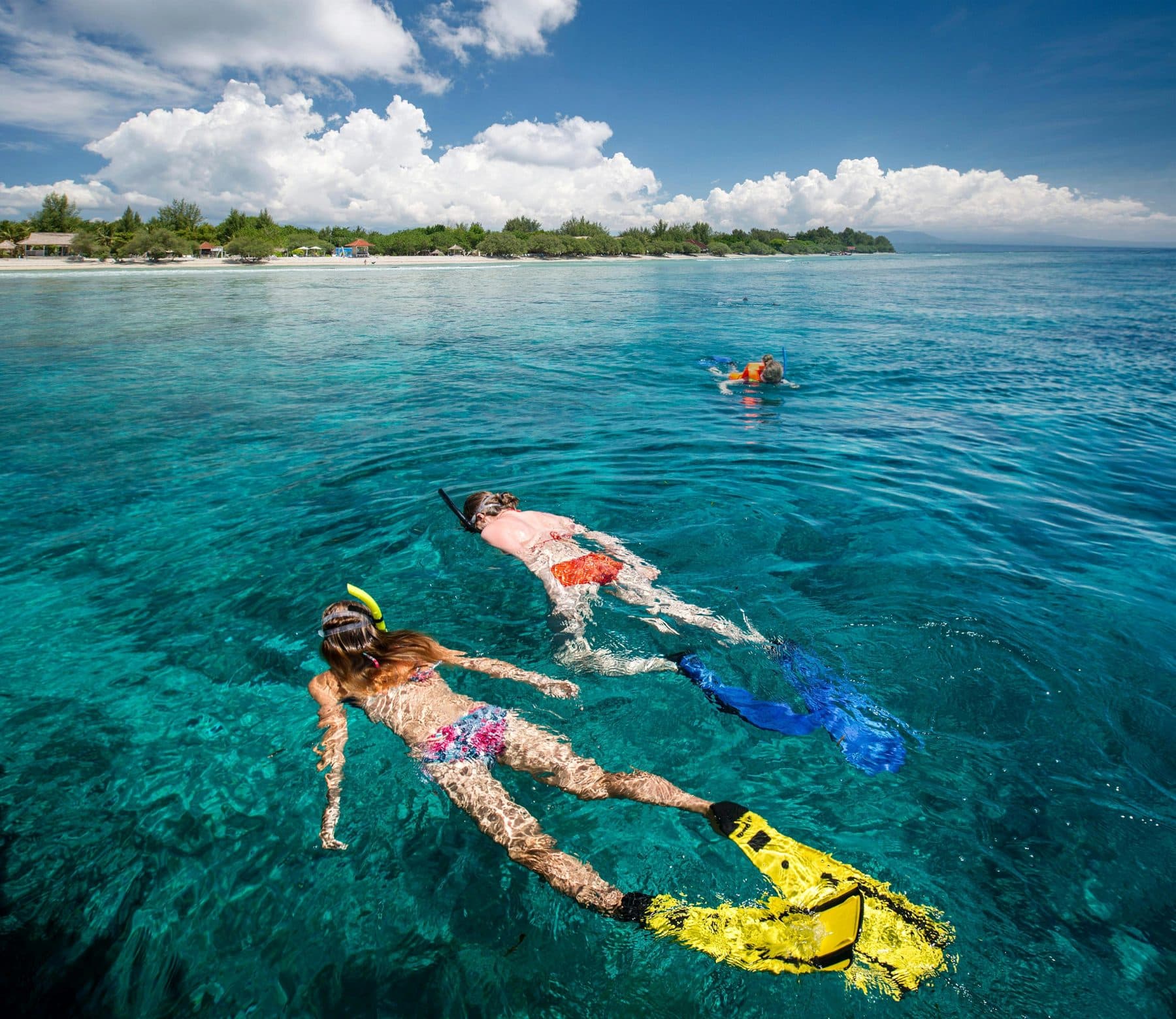 Snorkelers on the surface in clear Gili water