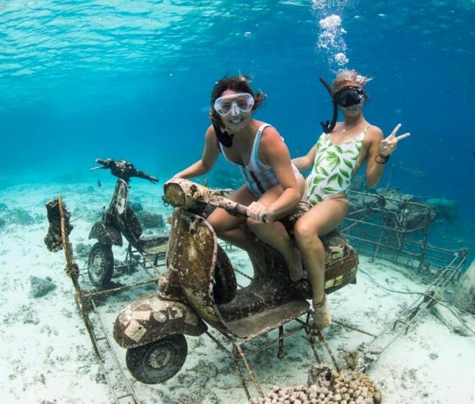Snorkelers at the underwater vespa sculptures