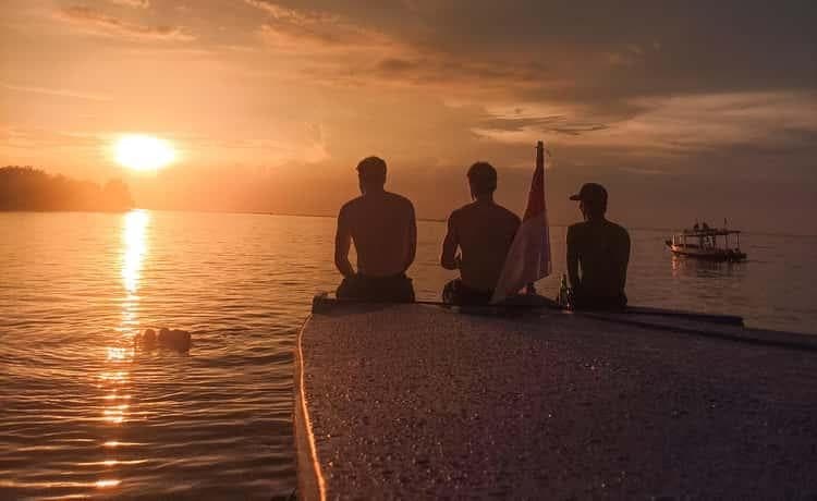 Guests sitting on the bow at sunset