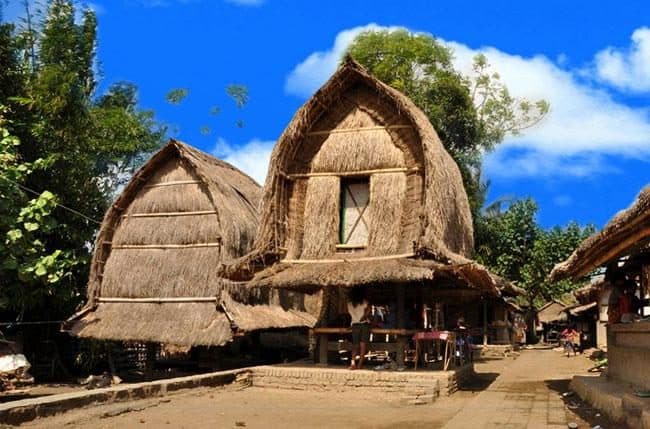 Twin thatched rice barns along the main path in Sade Sasak Village