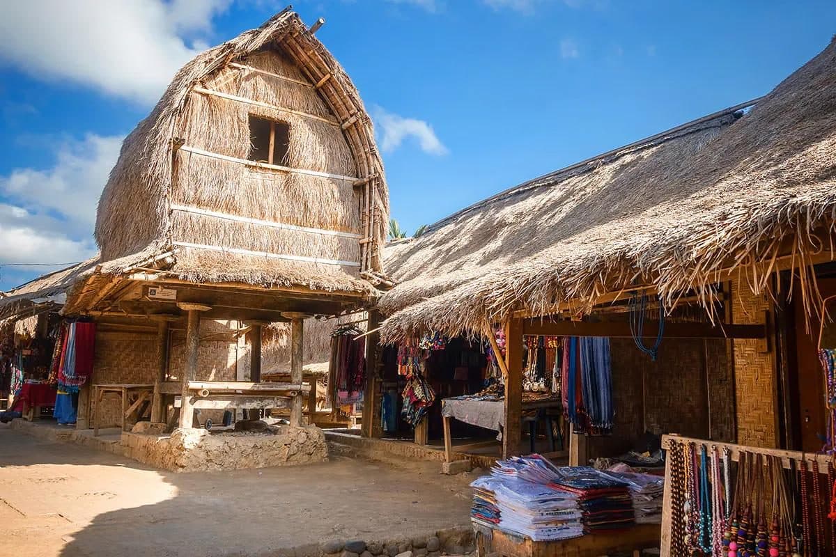 A thatched Sasak rice barn and souvenir stall in Sade Village