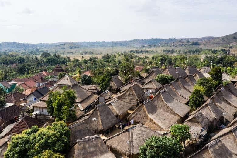Sade Village seen from above, with thatched houses and surrounding hills