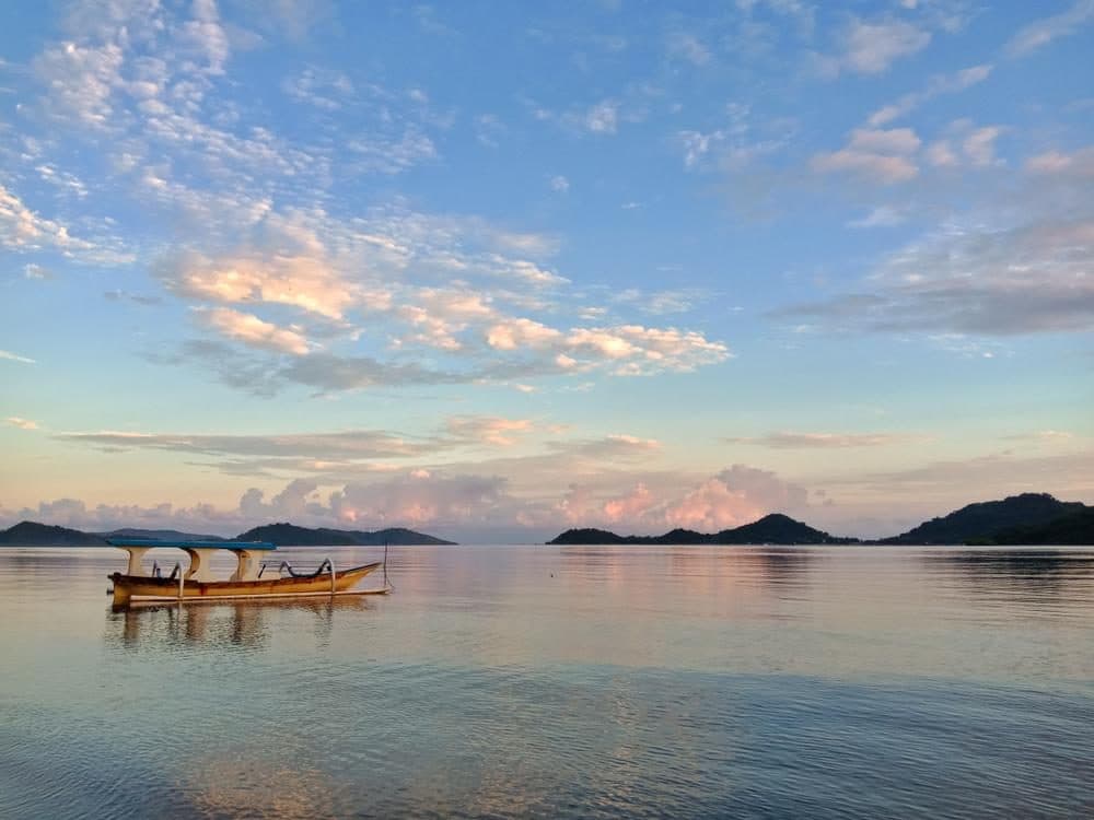 Traditional boat on calm water near Gili Gede