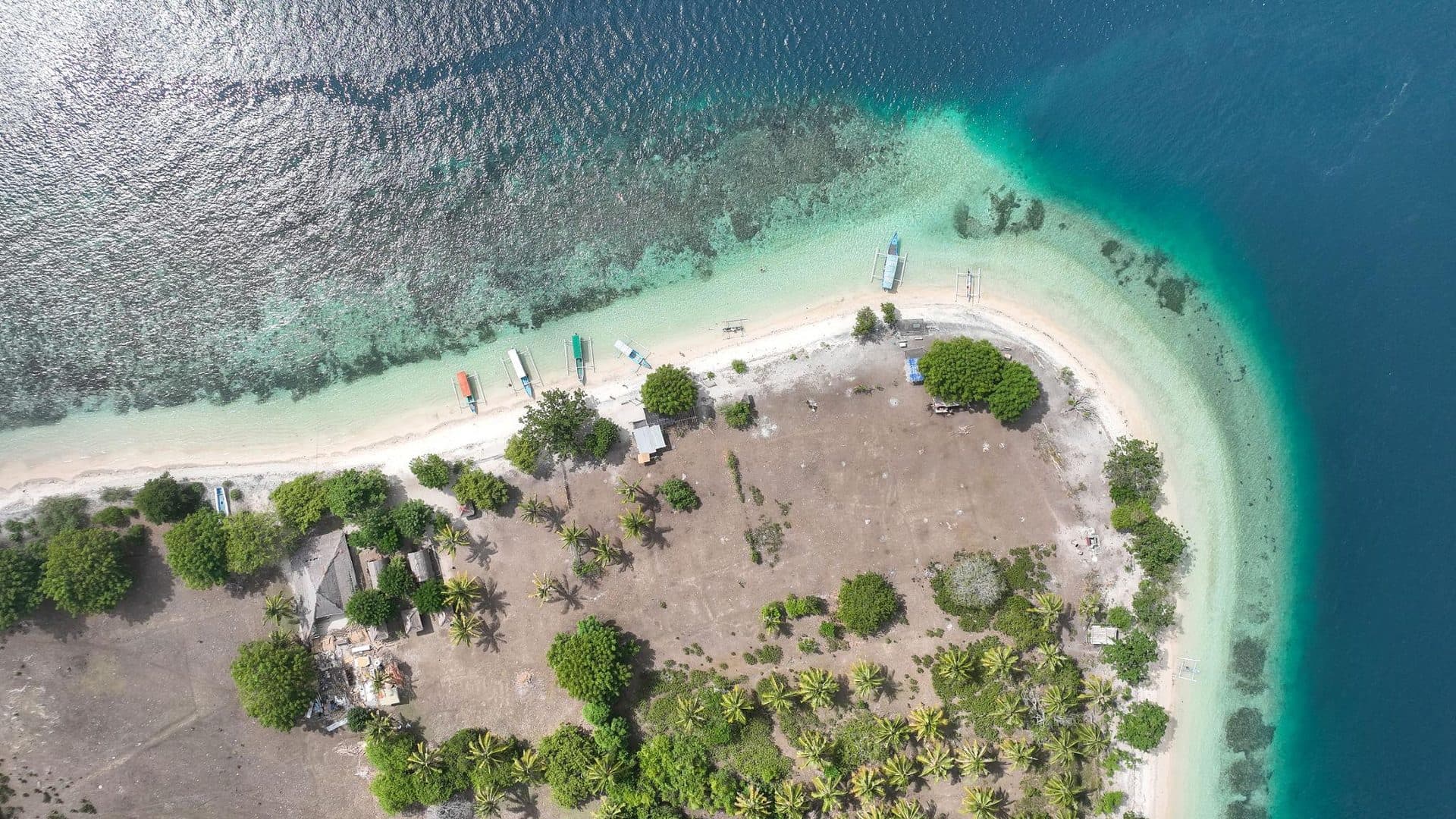 Undeveloped beach and clear water at Gili Layar