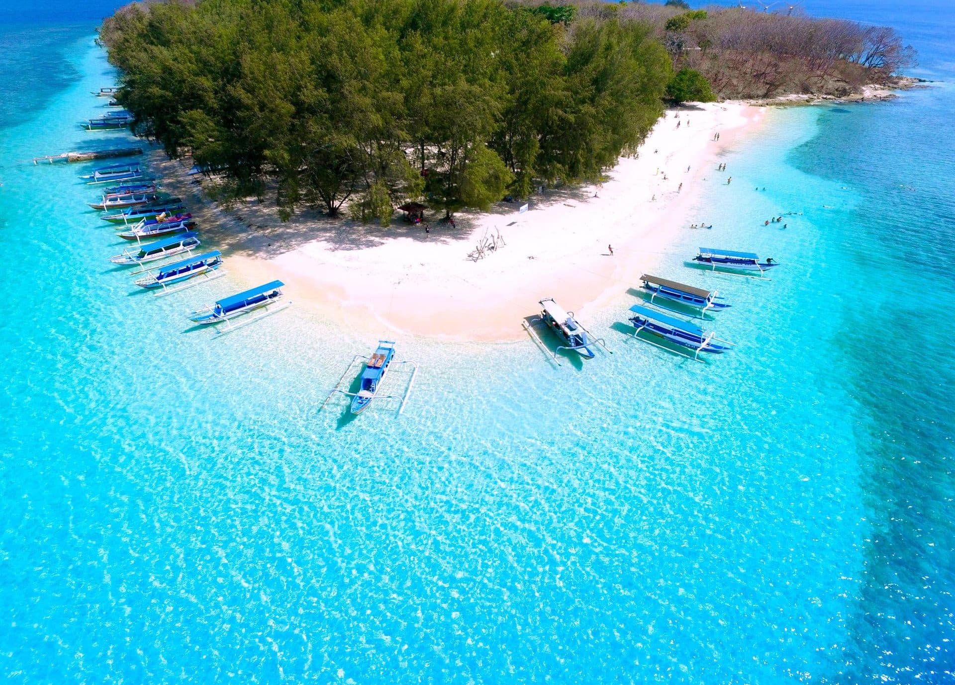 Boats along the white-sand beach of Gili Nanggu
