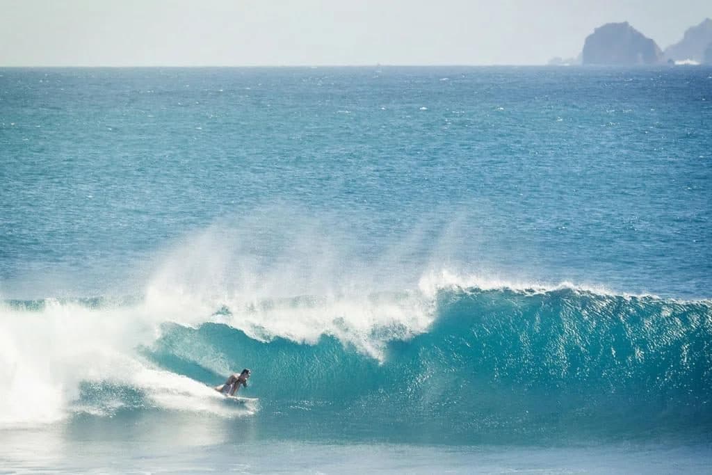 Surfer in a barreling wave at Mawi Beach
