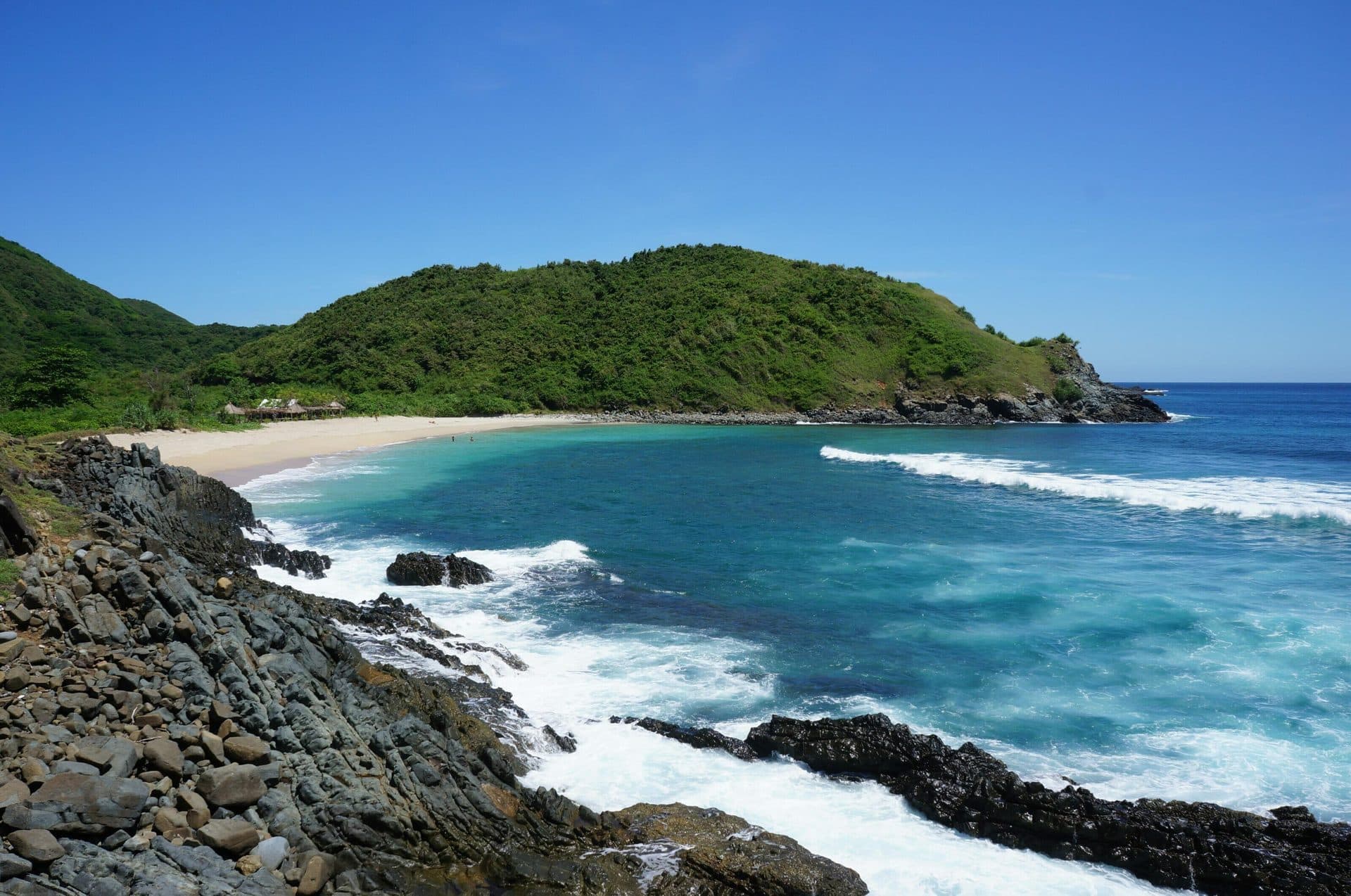 Rocky cove and turquoise water at Mawi Beach