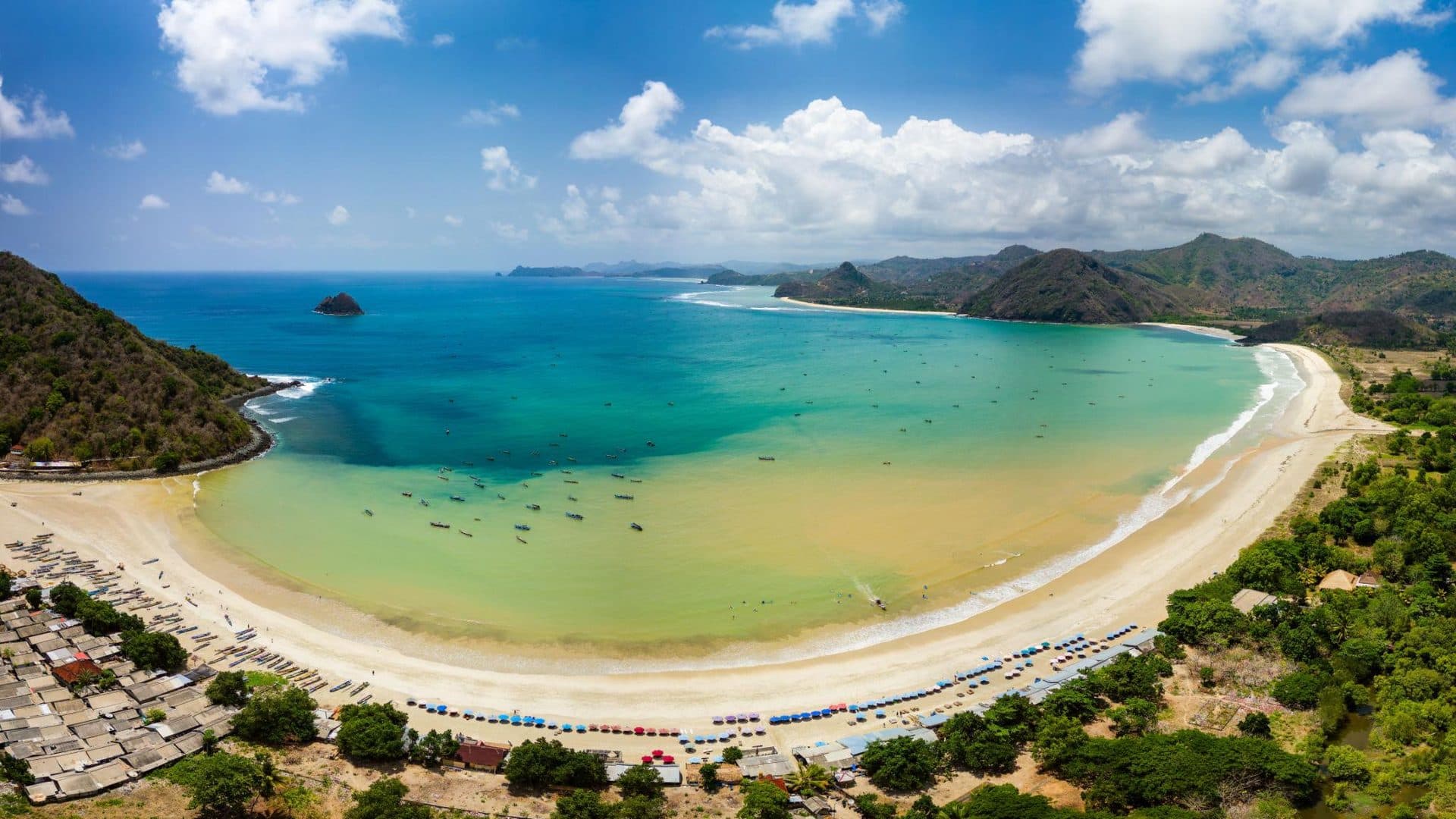 Crescent bay and gentle waves at Selong Belanak