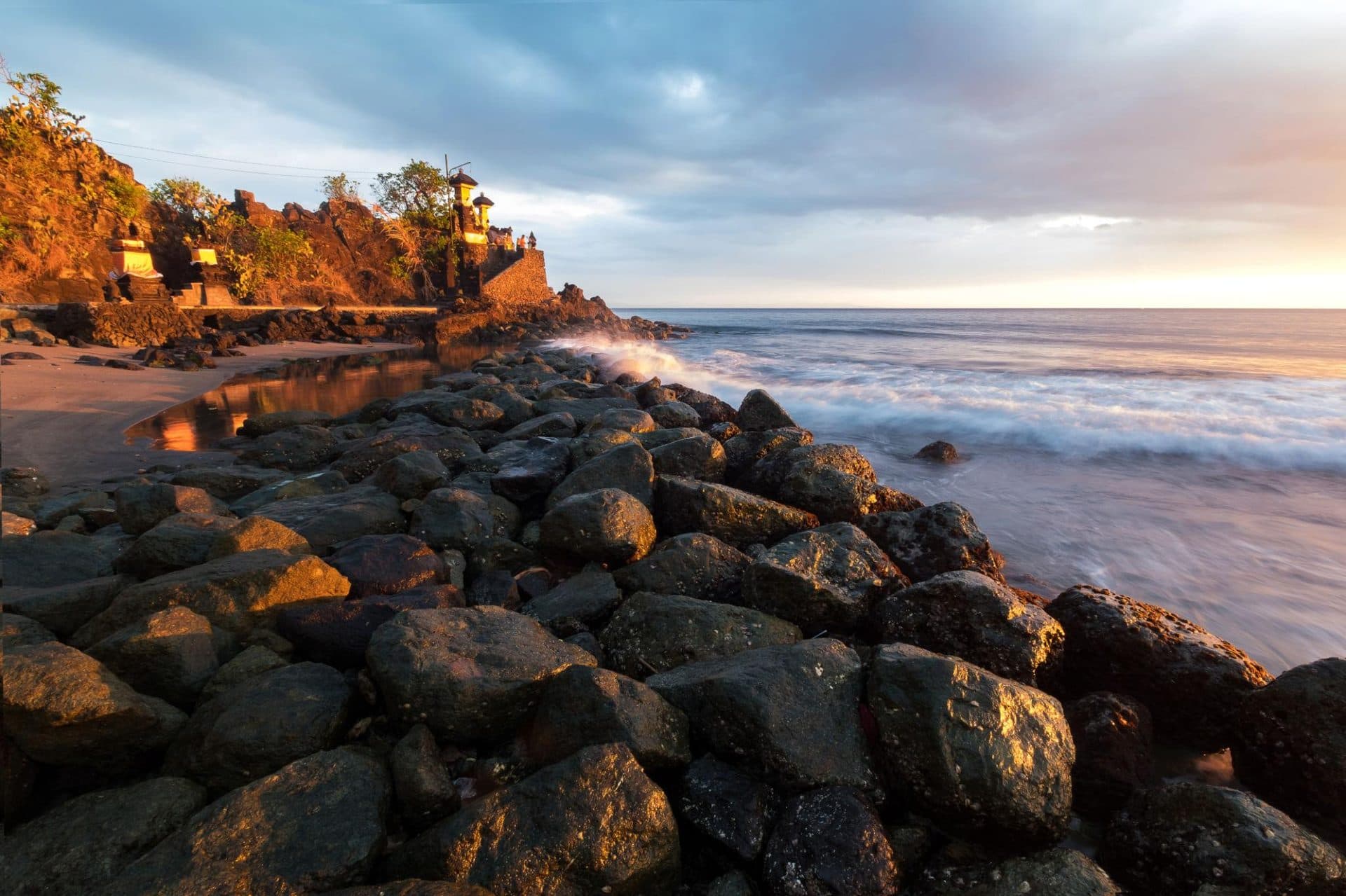 Sunset waves and rocks below the Senggigi sea temple
