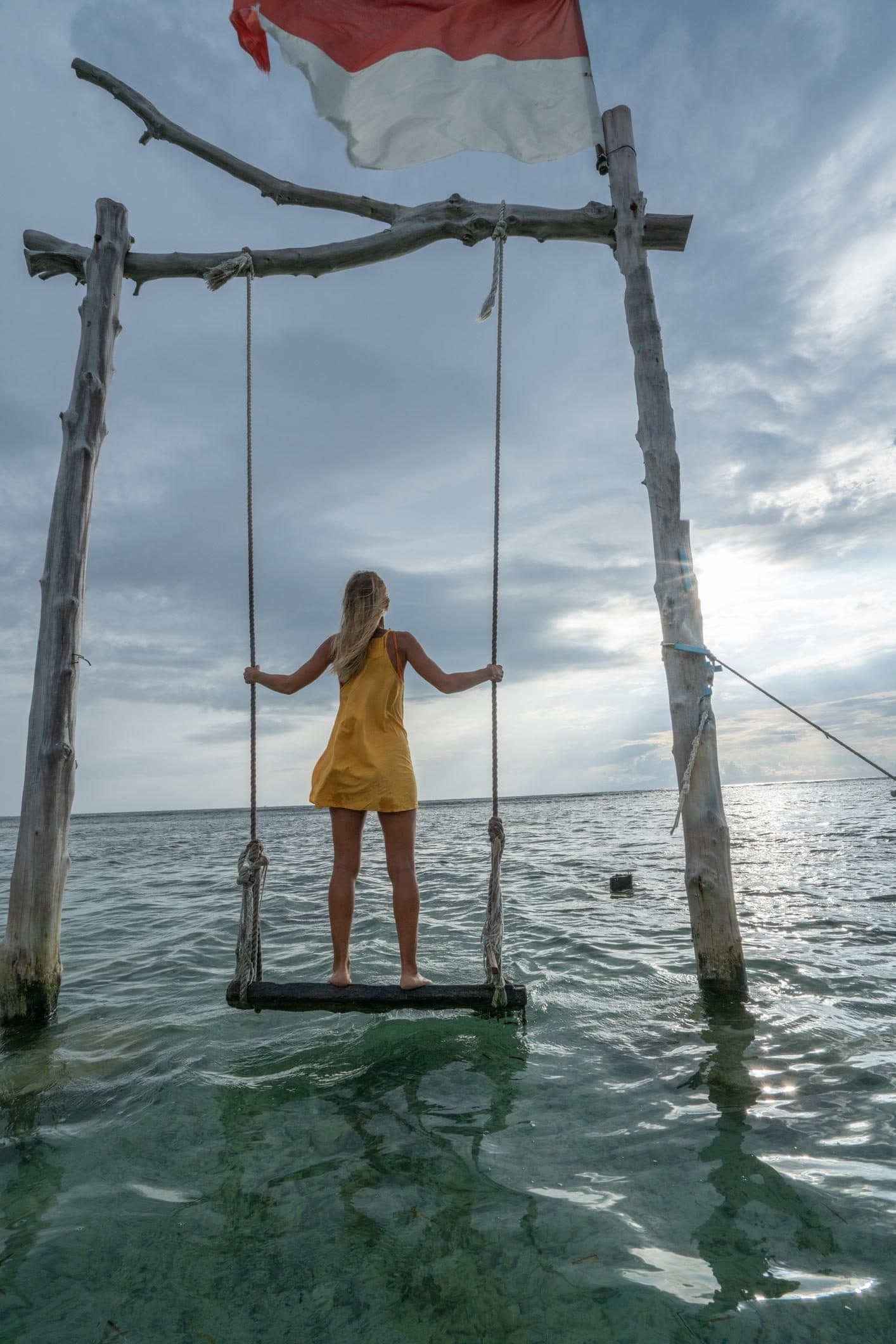 Sunset swing with the Indonesian flag on Gili Trawangan