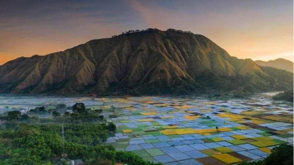 Sunset colors over Sembalun Valley’s blue and gold farm plots