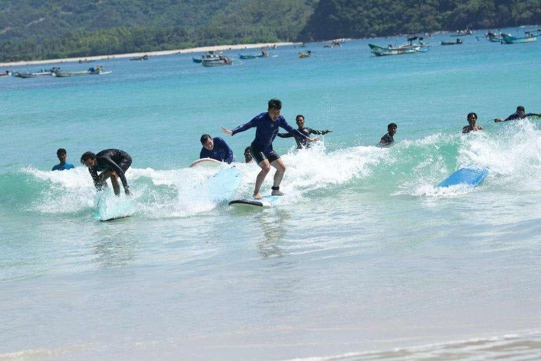 Surf students in a tropical bay