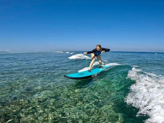 Standing up on a first wave in clear water